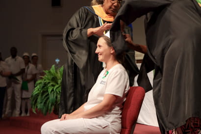 Female nursing graduate being capped