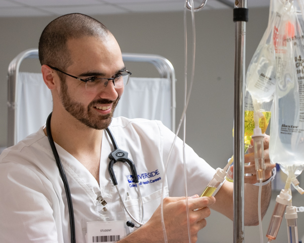 Male student looking at equipment in lab