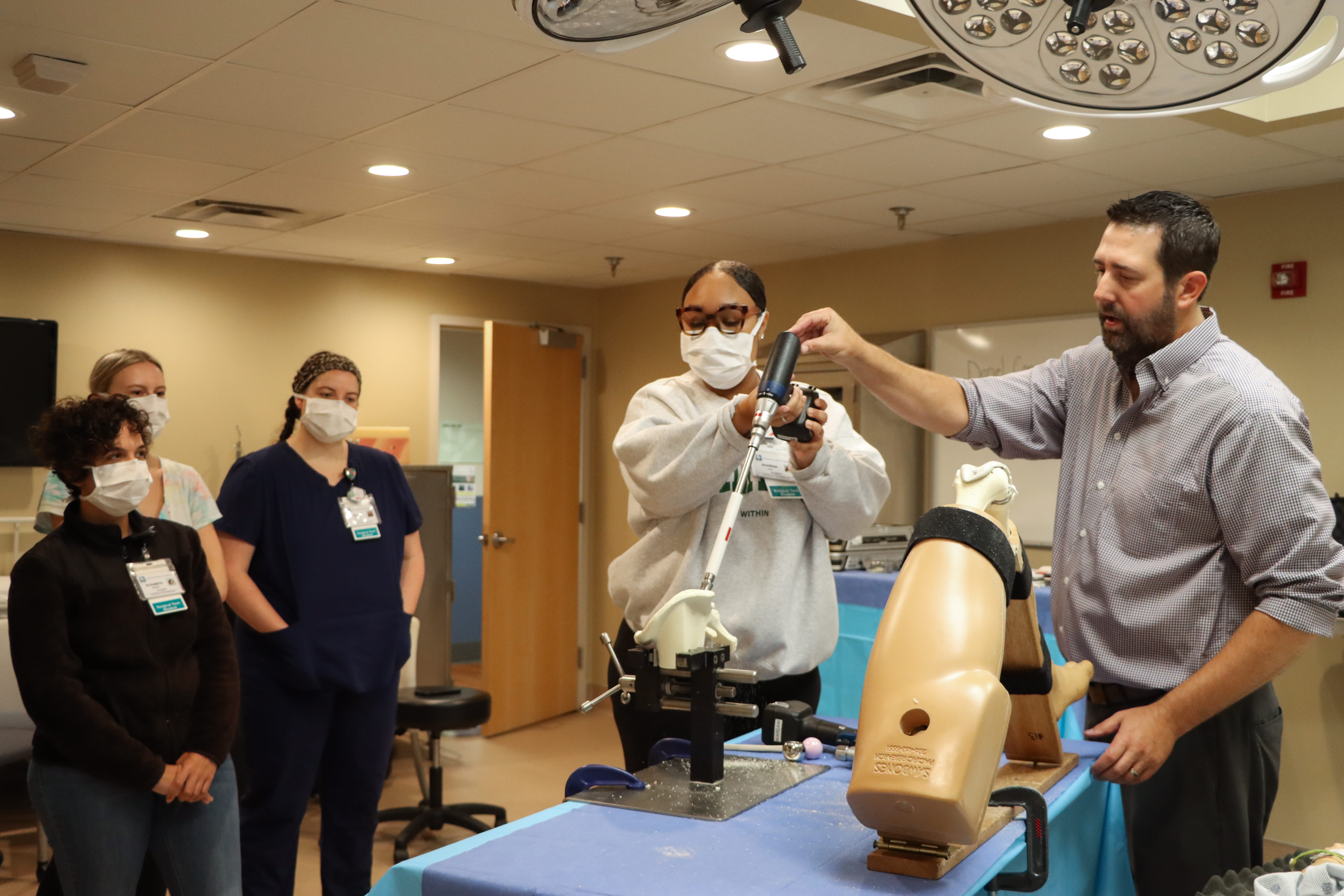 Man presents surgical technology tools to students.